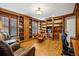 Bright home office with custom wood bookshelves, trim, hardwood flooring and a comfortable leather chair and gaming chair at 479 Josephine St, Denver, CO 80206