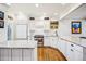 Bright kitchen featuring white cabinets, marble countertops, and stainless steel appliances at 479 Josephine St, Denver, CO 80206