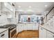 Open-concept kitchen with a center island, stainless steel appliances, and white cabinetry at 479 Josephine St, Denver, CO 80206