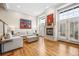 Spacious living room with hardwood floors, a fireplace, and large windows at 479 Josephine St, Denver, CO 80206