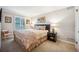 Bedroom with a large bed with decorative pillows and matching nightstands and side chair at 479 Josephine St, Denver, CO 80206