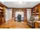 Office with built-in wooden bookcases, a wooden desk, and a leather chair at 479 Josephine St, Denver, CO 80206