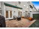 Back patio with brick pavers, stylish outdoor seating, garden decor, flower pots, awning and greenery at 479 Josephine St, Denver, CO 80206