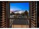 A window with wooden shutters provides an attractive view of the neighborhood and the sky at dusk at 479 Josephine St, Denver, CO 80206