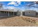 View of the backyard and detached garage from the lawn at 1227 Yost St, Aurora, CO 80011