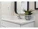 Bathroom vanity with quartz countertops, modern faucet, and contemporary decor at 1227 Yost St, Aurora, CO 80011