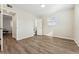 This bedroom features wood floors, bright natural light, and access to a connected bathroom at 1227 Yost St, Aurora, CO 80011