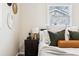 Relaxing bedroom with accent pillows, side table, and a view from the window at 1227 Yost St, Aurora, CO 80011