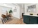 Bright dining area showcasing a wood table, sleek chairs, and modern decor adjacent to cabinetry with stone countertop at 1227 Yost St, Aurora, CO 80011