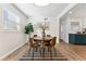 Charming dining area with a round table, stylish chairs, and a view into a bright kitchen at 1227 Yost St, Aurora, CO 80011