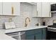 Stylish kitchen boasts white subway tile backsplash, quartz countertops, and gold hardware at 1227 Yost St, Aurora, CO 80011