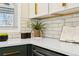 Kitchen featuring a quartz countertop, tiled backsplash, modern appliances, and stylish decor at 1227 Yost St, Aurora, CO 80011