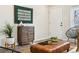 Inviting living room featuring stylish decor, a rustic wood cabinet, and an inviting front door at 1227 Yost St, Aurora, CO 80011