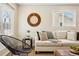 Bright living room showcasing a comfortable sofa and minimalist mirror with large windows for natural light at 1227 Yost St, Aurora, CO 80011