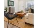 Cozy living room showcasing modern seating, a large rug, and great natural light through the window at 1227 Yost St, Aurora, CO 80011