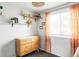 Bedroom with dresser, shelves, and peach-colored curtains at 4612 S Coors Ct, Morrison, CO 80465