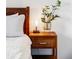 Wooden nightstand with mid-century modern lamp and plant adds style to bedroom at 4612 S Coors Ct, Morrison, CO 80465