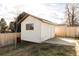 White detached shed with window and concrete slab at 4612 S Coors Ct, Morrison, CO 80465