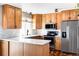 Modern kitchen with light wood cabinets, stainless steel appliances, and quartz countertops at 4612 S Coors Ct, Morrison, CO 80465