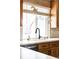 Kitchen sink with black faucet and farmhouse-style window at 4612 S Coors Ct, Morrison, CO 80465