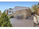 Charming backyard with wood patio, mature landscaping, and seating, perfect for outdoor living at 951 Tennyson St, Denver, CO 80204