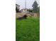 Spacious grassy backyard with a wooden privacy fence, perfect for outdoor enjoyment at 951 Tennyson St, Denver, CO 80204