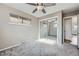 Cozy bedroom featuring gray carpet, ceiling fan, and mirrored closet doors at 951 Tennyson St, Denver, CO 80204