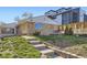 Brick home with a walkway and landscaped front yard at 951 Tennyson St, Denver, CO 80204