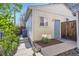 Garage exterior with separate entrance; lush plants offer privacy at 951 Tennyson St, Denver, CO 80204
