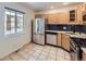 Bright kitchen showcasing stainless steel appliances, light wood cabinets, and tile flooring at 951 Tennyson St, Denver, CO 80204