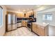 Well-lit kitchen featuring stainless steel appliances, granite counters, tile floor and dark backsplash at 951 Tennyson St, Denver, CO 80204