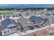 Residential homes in a neighborhood, showcasing snow-dusted landscaping and mountain views in the background at 692 Sage Forest Ln, Monument, CO 80132