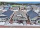 An aerial view of a home with blue shutters and inviting porch and manicured landscaping at 692 Sage Forest Ln, Monument, CO 80132