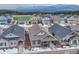 Overhead view featuring houses in a neighborhood surrounded by trees, sports field, and mountain views at 692 Sage Forest Ln, Monument, CO 80132