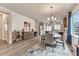 Open dining area with seating for four, hardwood floors, and decorative shiplap wall at 692 Sage Forest Ln, Monument, CO 80132