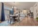 Open dining area with seating for four and hardwood floors next to the living room with fireplace at 692 Sage Forest Ln, Monument, CO 80132