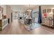 Open dining and kitchen area with barstool seating, wood floors, modern chandelier, and natural light at 692 Sage Forest Ln, Monument, CO 80132