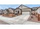 Charming single Gathering home featuring a spacious driveway, two car garage, and fenced front yard at 692 Sage Forest Ln, Monument, CO 80132