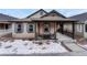 Inviting front porch with seating area, perfect for enjoying quiet moments outdoors at 692 Sage Forest Ln, Monument, CO 80132