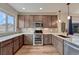 Modern kitchen with stainless steel appliances, stylish cabinets, and a bright window at 692 Sage Forest Ln, Monument, CO 80132