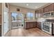 Open kitchen featuring stainless steel appliances, granite countertops, and hardwood floors at 692 Sage Forest Ln, Monument, CO 80132