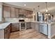 Contemporary kitchen showcasing stainless steel appliances, granite counters, and wood cabinetry at 692 Sage Forest Ln, Monument, CO 80132