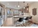 Modern kitchen featuring stainless steel appliances, lovely hardwood floors, and breakfast bar seating at 692 Sage Forest Ln, Monument, CO 80132
