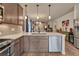 Well-lit kitchen featuring an island with modern appliances and open-concept design to the living area at 692 Sage Forest Ln, Monument, CO 80132