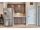 Kitchen area featuring stainless steel refrigerator, wood cabinets, and ample storage at 692 Sage Forest Ln, Monument, CO 80132