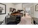 Living Room with a black grand piano and open view to the dining room at 692 Sage Forest Ln, Monument, CO 80132