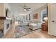 Open-concept living room with hardwood floors, a fireplace, and ample natural light at 692 Sage Forest Ln, Monument, CO 80132
