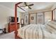 Comfortable bedroom featuring a cozy bed, ceiling fan and large windows at 692 Sage Forest Ln, Monument, CO 80132