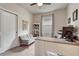 Home office with a built-in desk, a comfortable gray futon, and a bright window at 692 Sage Forest Ln, Monument, CO 80132