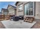 An outdoor patio seating area with a fire table and comfortable seating for outdoor relaxation at 692 Sage Forest Ln, Monument, CO 80132